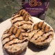 Caramel Delites Cupcakes: Toasted coconut cupcake with caramel buttercream, toasted coconut, chocolate ganache stripes and a cookie