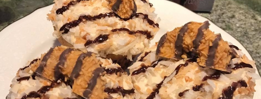 Caramel Delites Cupcakes: Toasted coconut cupcake with caramel buttercream, toasted coconut, chocolate ganache stripes and a cookie