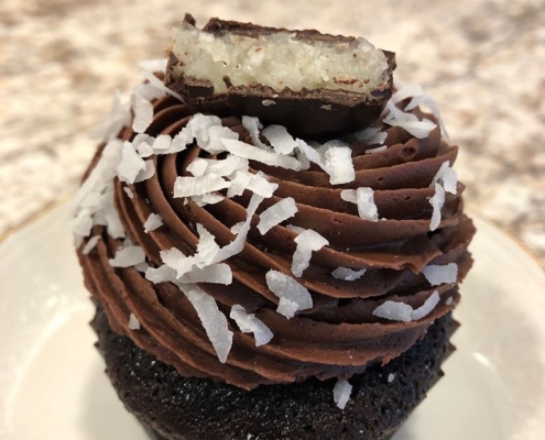 Mount Desert Mounds Cupcake: Chocolate cupcake with dark chocolate buttercream, coconut and a Mounds bar slice