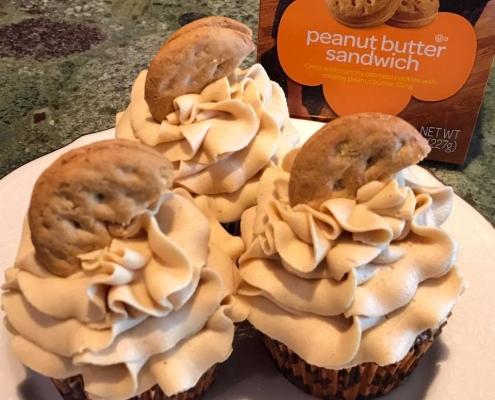 PB Sandwich Cupcakes: Oatmeal cupcake baked with cookie pieces with peanut butter buttercream and a cookie