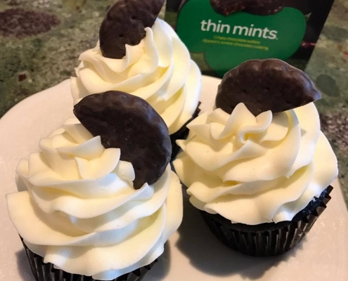 Thin Mints Cupcakes: Chocolate cupcake baked with cookie pieces with mint buttercream and a cookie