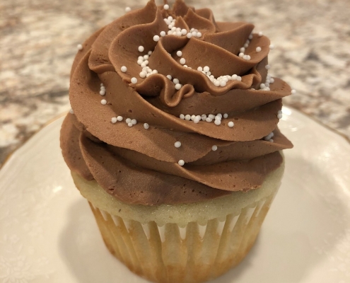 Acadia's Friend Cupcake: Vanilla bean cupcake with chocolate buttercream and white sprinkles