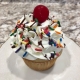 Celebration Cupcake: Vanilla cupcake with vanilla buttercream, chocolate ganache drizzle, rainbow sprinkles and a maraschino cherry