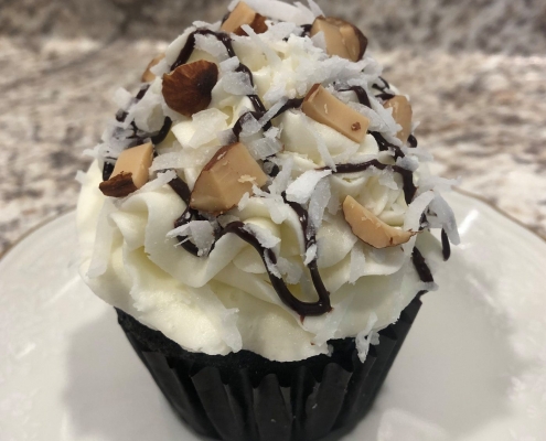 Sweet Sister Cupcake: Chocolate cupcake with almond buttercream, coconut, chocolate ganache drizzle and chopped almonds