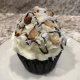Sweet Sister Cupcake: Chocolate cupcake with almond buttercream, coconut, chocolate ganache drizzle and chopped almonds