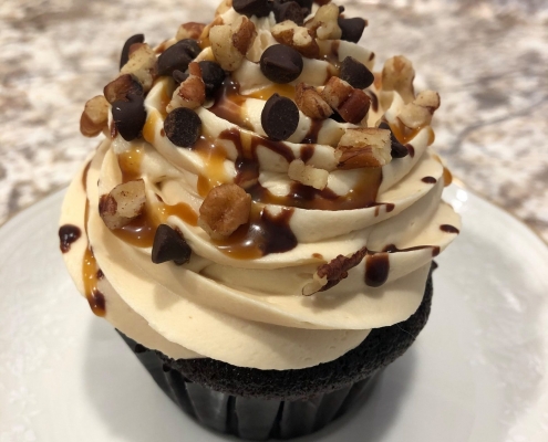 Turtle Cupcake: Chocolate cupcake with caramel buttercream, chocolate ganache drizzle, caramel sauce drizzle and pecans (or chocolate chips for nut-free option)