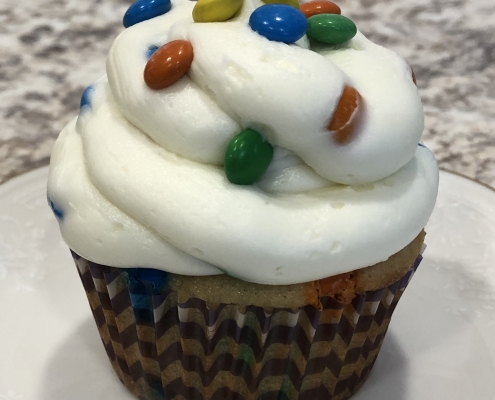 Chickadee Cupcake: M&M cupcake with vanilla M&M buttercream and mini M&Ms