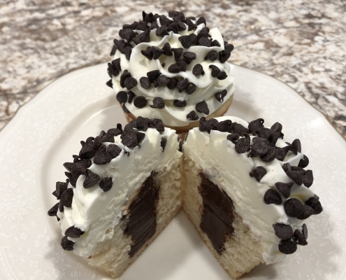 Chocolate Chip Charm Cupcake: Vanilla cupcake with chocolate ganache filling, vanilla buttercream and mini chocolate chips