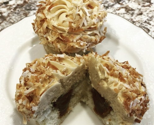 Coconut Carnival Cupcake: Coconut cupcake with dulce de leche filling with dulce de leche buttercream and toasted coconut