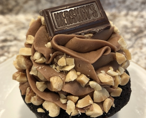 Nutty Neighbor Cupcake: Chocolate cupcake with chocolate buttercream, chopped peanuts and a Mr. Goodbar