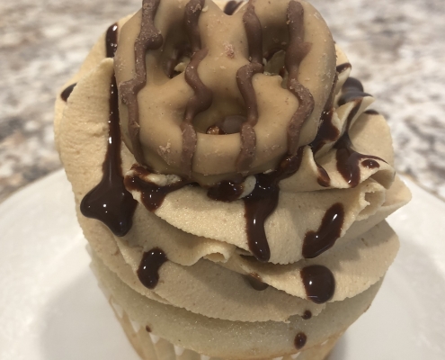 Pine Point PB Cupcake: Vanilla cupcake with peanut butter buttercream, chocolate ganache drizzle and a Reese's peanut butter dipped pretzel