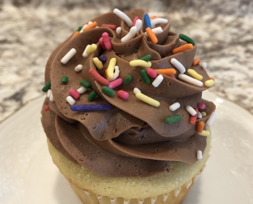 Childhood Classic Cupcake: Yellow cupcake with chocolate buttercream and rainbow sprinkles