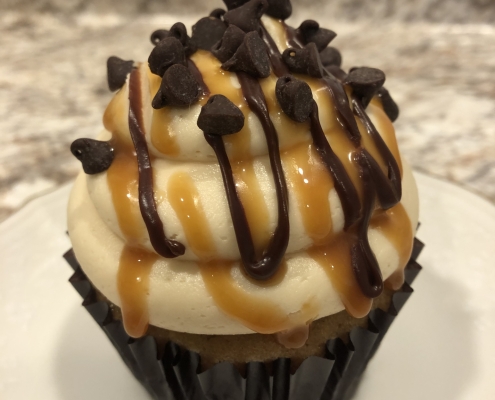 Casco Bay Caramel Chip Cupcake: Caramel chocolate chip cupcake with salted caramel buttercream, chocolate ganache drizzle, caramel sauce drizzle and mini chocolate chips