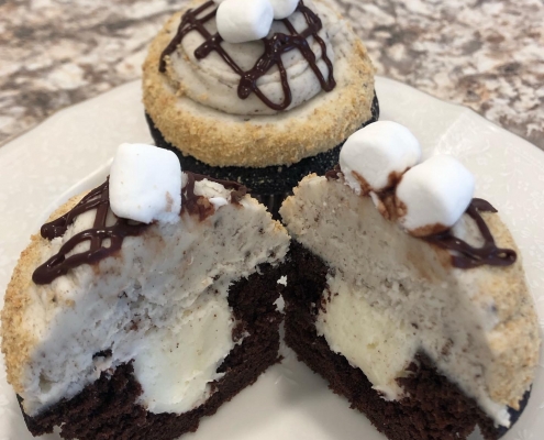 S'moreo Cupcake: Chocolate cupcake with marshmallow filling, cookies-n-creme buttercream, graham cracker crumbs, chocolate ganache drizzle, Oreo cookie and mini marshmallows