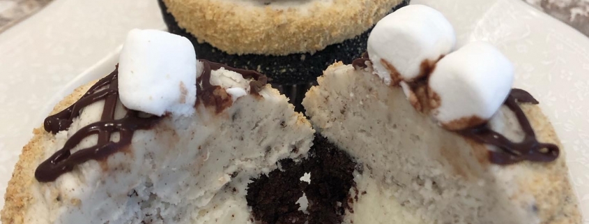 S'moreo Cupcake: Chocolate cupcake with marshmallow filling, cookies-n-creme buttercream, graham cracker crumbs, chocolate ganache drizzle, Oreo cookie and mini marshmallows
