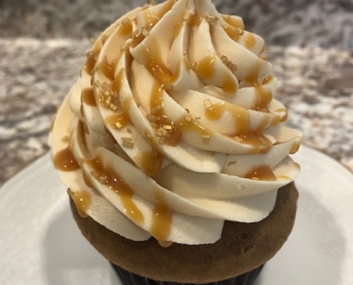 Caramel Cafe Cupcake: Coffee cupcake with salted caramel buttercream, caramel sauce drizzle and gold sprinkles