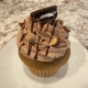 Mud Pie Cupcake: Coffee cupcake with mocha buttercream, chocolate ganache drizzle, chopped almonds, peanut butter chips and a mini Oreo cookie