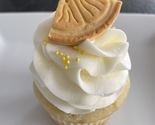 Lemonade Cupcake: Lemon cupcake with lemon buttercream, yellow sprinkles and a cookie