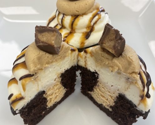 Slice of Heaven Cupcake: Chocolate cupcake with peanut butter buttercream filling, cream cheese buttercream, caramel sauce and chocolate ganache drizzle and a peanut butter cup